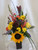 Fancy Free Sunflower Rose Bouquet by Enchanted Florist Pasadena TX. A pretty mixed flower vase arrangement that includes sunflowers, snapdragons, yellow roses, and more in a dark colored vase. RM164
