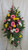 Beautiful Farewell Pink Sympathy Spray of Flowers by Enchanted Florist Pasadena TX.  A mixed color spray of sympathy flowers in a standing spray and includes pink gerbera daises, yellow roses, pink larkspur and yellow snapdragons. Cheap funeral flowers. RM539