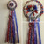 The Red, White, and Blue Homecoming Mum from Enchanted Florist can be designed in any color for any school. It includes a single mum flower, trinkets, a chain, and a braid as shown. Two names are also included in the price. HMC106