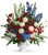 Patriotic Funeral Flowers Arrangement by Enchanted Florist Pasadena TX. A patriotic mix of all-American red, white and blue flowers such as hydrangea, roses, miniature carnations, snapdragons, mums and more are perfectly arranged in a white urn. Approximately 31" W x 34" H
SKU RM573