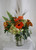 Autumn Dew Drops Bouquet in Orange from Enchanted Florist. Your beautiful fall bouquet will arrive in a clear vase and includes hydrangeas, orange roses, orange gerbera daisies, alstromeria and butterscotch daisies and is accented with sword fern and wheat grass. Approximately 13"W x 17"H
SKU RM212