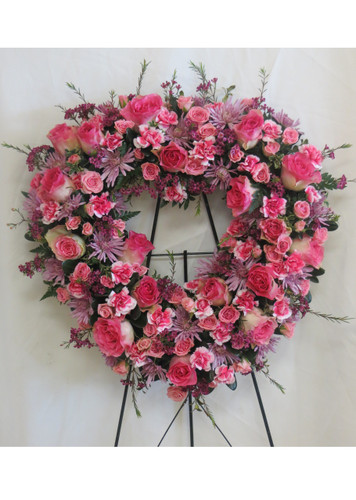 Heart shaped memorial wreath with pink roses and white stocks