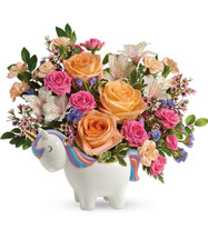 Magic Unicorn Flower Bouquet from Enchanted Florist. This unicorn flower bouquet includes peach roses, pretty pink spray roses, white alstroemeria, peach miniature carnations, statice, and pink waxflower. It is  accented with assorted greenery and hand delivered in a Charmed Unicorn Keepsake they will treasure for a lifetime. SKU RM172