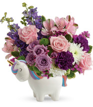 Magical Mood Unicorn in Purple Enchanted Florist. This magical gift features lavender spray roses, pink alstroemeria, fuchsia carnations, purple larkspur, white cushion spray chrysanthemums, green button spray chrysanthemums, raspberry statice, and variegated pitt. Delivered in a Charmed Unicorn Keepsake. Approximately 12" W x 13" H
SKU RM133