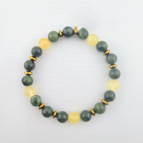 Jade and citrine gemstone bead bracelet laid flat showing alternating green jade and yellow citrine beads with gold accent spacers.
