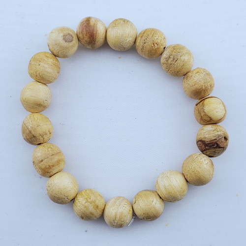 Single Palo Santo bead bracelet laying flat on a white background