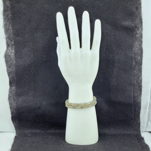 Polished Labradorite bead bracelets stacked on a white mannequin hand display showing blue flashes.
