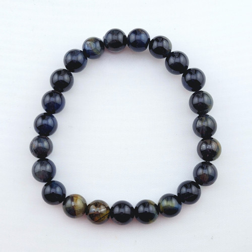 Top-down view of a 8mm Blue Tigers Eye bracelet highlighting natural dark stone variations.