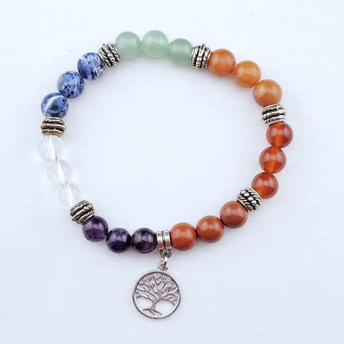 A single chakra alignment bracelet showcasing a rainbow sequence of polished natural stones on a white background.