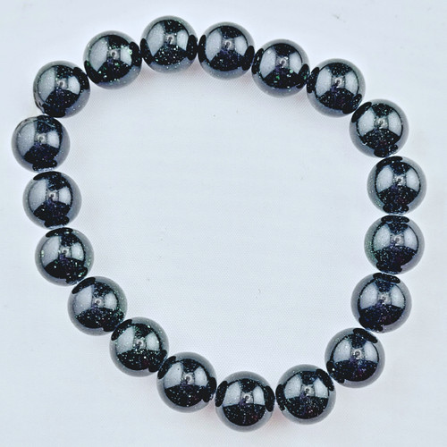 A single Green Goldstone stretch bracelet laid flat on a white surface showing the uniform 10mm beads.