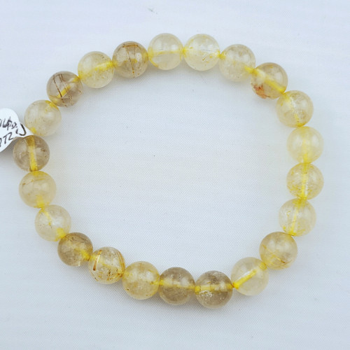 A Rutilated Quartz stretch bracelet featuring 8mm clear beads with golden needle-like rutile inclusions on a white background.