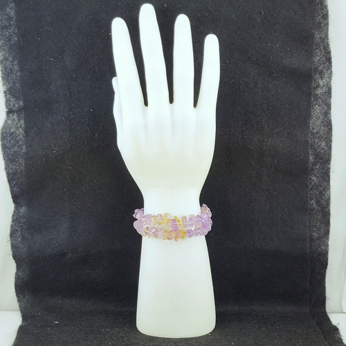 A stack of Ametrine chip bracelets displayed on a white mannequin hand to show the organic texture and fit.