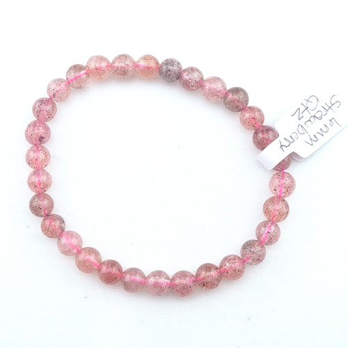 Strawberry Quartz stretch bracelet 6mm beads featuring translucent pink beads with natural dark red inclusions on a white display.