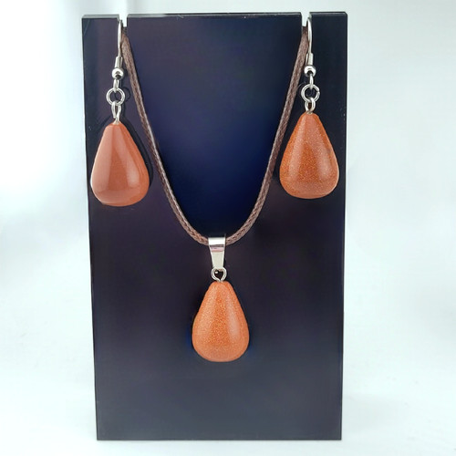 A Goldstone teardrop gemstone jewelry set including a pendant on a braided cord and matching drop earrings.