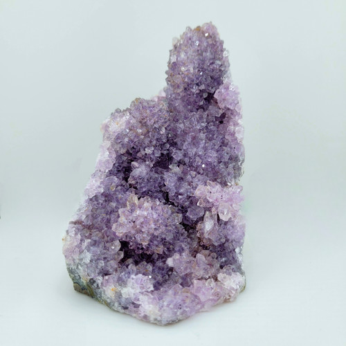 Front view of a vertical Amethyst raw cluster stand featuring pale purple crystal points on a white background.