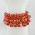 Close-up of carnelian gemstone beads showing natural banding and color variation