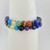 Close-up of R3 Wellness chakra bracelet showing lapis lazuli and multicolor chakra beads