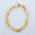 8mm Citrine crystal bracelet from R3 Wellness laid flat showing round polished gemstone beads