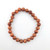 Goldstone 8mm bead bracelet laid flat on white background