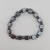 Hematite square and round bead bracelet laid flat showing alternating geometric shapes and metallic gray stones.