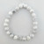 White howlite 8mm bead bracelet with gray marbling displayed laying flat on white background