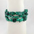 Close-up of malachite chip bracelet showing polished green stones with natural banding