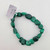 Single malachite chip bracelet laid flat showing polished green banded stones