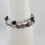 Close-up of rutilated quartz bracelet showing clear and smoky quartz beads with natural rutile threads
