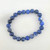Sodalite 8mm bead bracelet photographed flat showing round blue beads with natural white marbling.