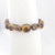 Close-up of tiger’s eye chip bracelet showing natural brown and gold banded polished stone chips.
