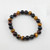 Triple tiger eye 8mm bead bracelet laid flat showing mixed gold red and blue tiger eye stones