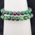 Close-up of ruby zoisite 8mm beads showing green and pink natural stone pattern