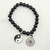 Close-up of Yin Yang and Evil Eye charms showing polished textures.