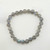 A Labradorite stretch bracelet resting on a white surface.