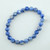 Overhead view of a natural Blue Kyanite bracelet showing the unique mineral variations in each bead.