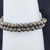 Close-up detail of 6mm Pyrite gemstone beads showing metallic gold luster and natural surface variations.