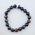 10mm bead Blue Tigers Eye stretch bracelet laid flat on a white background.