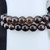 Close-up detail of Smoky Quartz beads showcasing natural clarity and rich earthy gradients.
