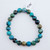 A single Chrysocolla stretch bracelet featuring 8mm polished beads with vibrant blue, green, and brown swirling patterns on a white background.