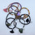 A stack of bracelets loosely arrange on a white background to showcase the organic color variation.