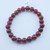 A single Red Agate stretch bracelet with 8mm polished beads in deep crimson and burnt orange tones.