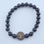 Sleek Black Obsidian stretch bracelet with polished black beads and a black wood Tree of Life charm.