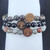 Close-up detail of Dragon Blood Jasper, Black Obsidian, and African Bloodstone beads with engraved wooden charms.
