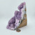 Angled view of a purple Amethyst specimen highlighting the dense crystal formations and rugged mineral exterior.