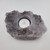 Top-down view of a pale Amethyst raw cluster tea light holder with a white tea candle in the center.