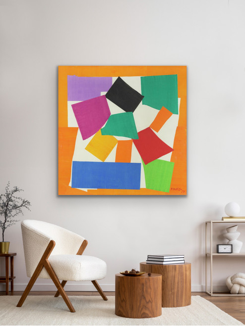 A 44-inch square matte archival print of Henri Matisse's The Snail (1953) displayed on a living room wall. The large-format abstract cut-out print features a dynamic spiral of vibrant orange, deep blue, green, and yellow geometric paper shapes, serving as a high-energy focal point in a modern home interior.
