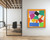 An architectural-scale 60-inch square fine art print of Henri Matisse's The Snail hanging on a minimalist white office wall. The non-reflective, heavy 330gsm matte print captures the raw, saturated color blocks and precise edges of the original paper cut-out masterpiece in a contemporary workspace.