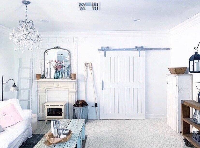 two panel white painted barn door in a bedroom