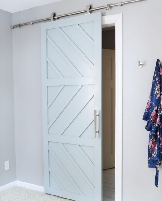 custom wood sliding barn door in baby blue with geometric pattern