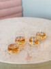 Monti-Shot Clear shot glasses. Picture shows angled view of 4 filled glasses in a lifestyle setting